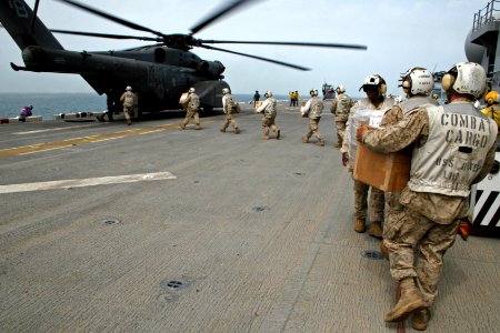 US Navy 070412-N-1328S-007 USS Boxer's (LHD 4) combat cargo Marines unload mail, equipment and cargo during the 15th Marine Expeditionary Unit's return from conducting operations in Iraq
