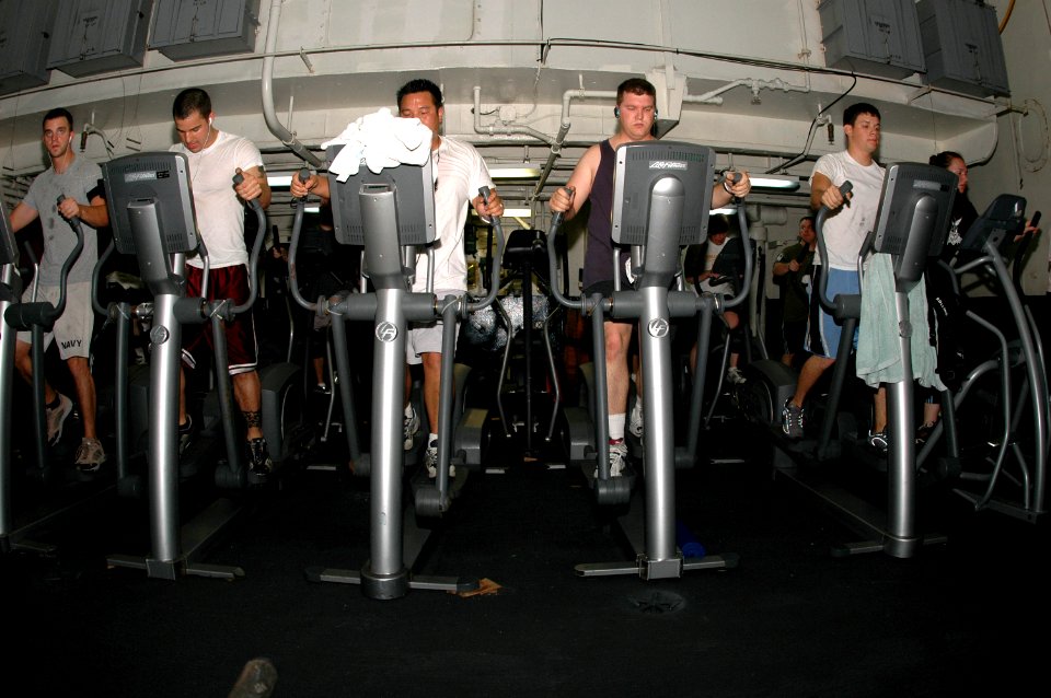 US Navy 070409-N-5484G-006 Sailors and Marines exercise on elliptical trainers in the hanger bay of the nuclear-powered aircraft carrier USS Nimitz (CVN 68)