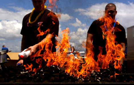 US Navy 070409-N-7130B-278 Sailors aboard USS Ronald Reagan (CVN 76) use lighter fluid to start the grill for a steel beach picnic on the flight deck