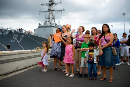 US Navy 070407-N-4856G-027 Families of Sailors stationed aboard guided missile destroyer USS Russell (DDG 59) wait patiently as the ship returns to Naval Station Pearl Harbor from a three-month deployment