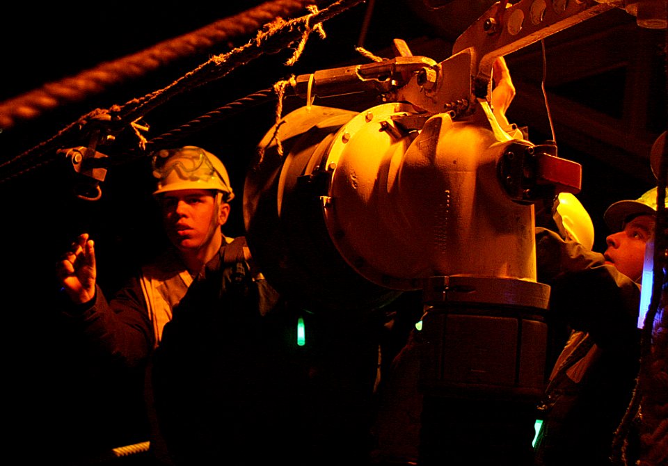 US Navy 070406-N-4953E-001 Boatswain's Mate 3rd Class Robert Barrios gives instructions to line handlers as they heave the line to seat the fuel probe during an underway replenishment