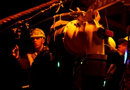 US Navy 070406-N-4953E-001 Boatswain's Mate 3rd Class Robert Barrios gives instructions to line handlers as they heave the line to seat the fuel probe during an underway replenishment