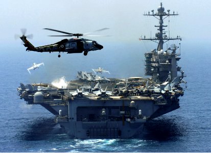 US Navy 070413-N-0684R-353 An SH-60F Seahawk, from the Eightballers of Helicopter Anti-Submarine Squadron (HS) 8, hovers in the air as Nimitz-class aircraft carrier USS John C. Stennis (CVN 74)