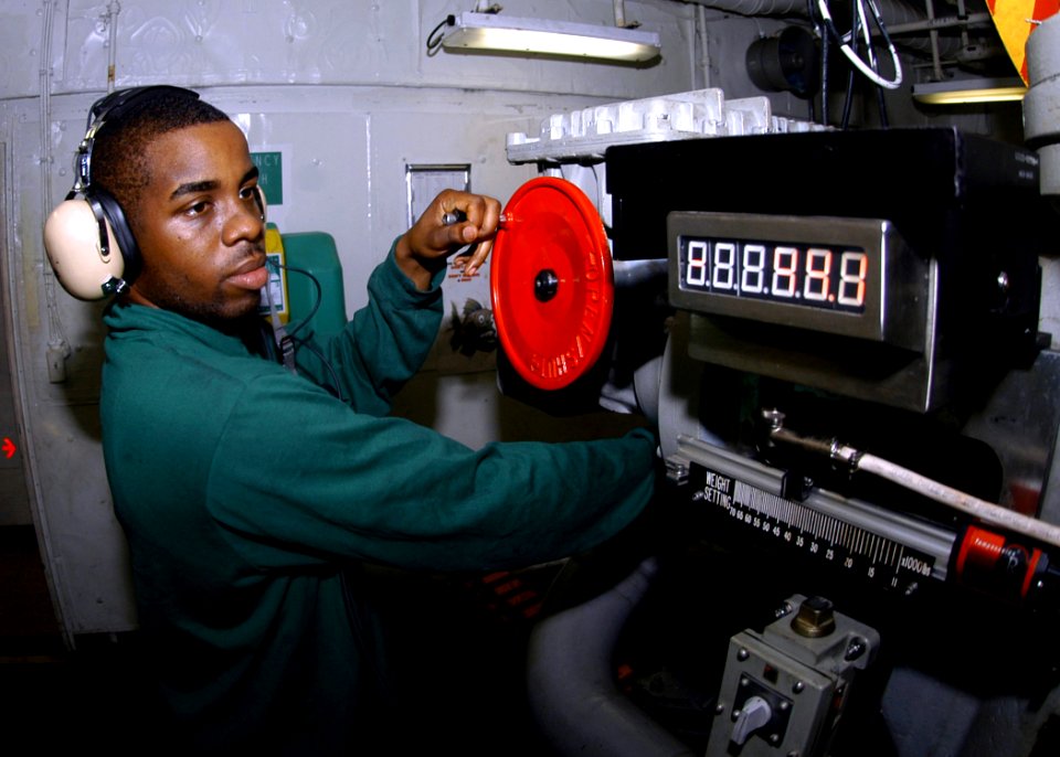 US Navy 070413-N-8446A-003 Aviation Boatswain's Mate Airman Leonid Peets sets the arresting aircraft weight while manning an arresting gear engine aboard the Nimitz-class aircraft carrier USS Dwight D. Eisenhower (CVN 69)