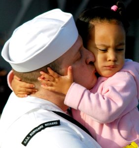 US Navy 070410-N-4163T-063 A Sailor kisses his daughter goodbye as he prepares to depart on a six-month deployment on the multi-purpose amphibious assault ship USS Bonhomme Richard (LHD 6)