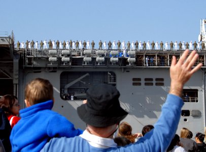US Navy 070410-N-1722M-259 Family members wave goodbye to the Sailors and Marines aboard USS Bonhomme Richard (LHD 6) as the ship leaves Naval Station San Diego