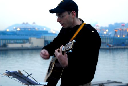 US Navy 070408-N-4124C-007 Ensign Alex Sicola, assigned to amphibious assault ship USS Essex (LHD 2), plays a hymn during a Sunrise Easter Service on the ship's flight deck