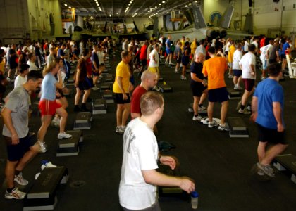US Navy 070414-N-6854D-006 Sailors participate in a two-hour aerobics class held in the hangar bay of Nimitz-class aircraft carrier USS Dwight D. Eisenhower (CVN 69)