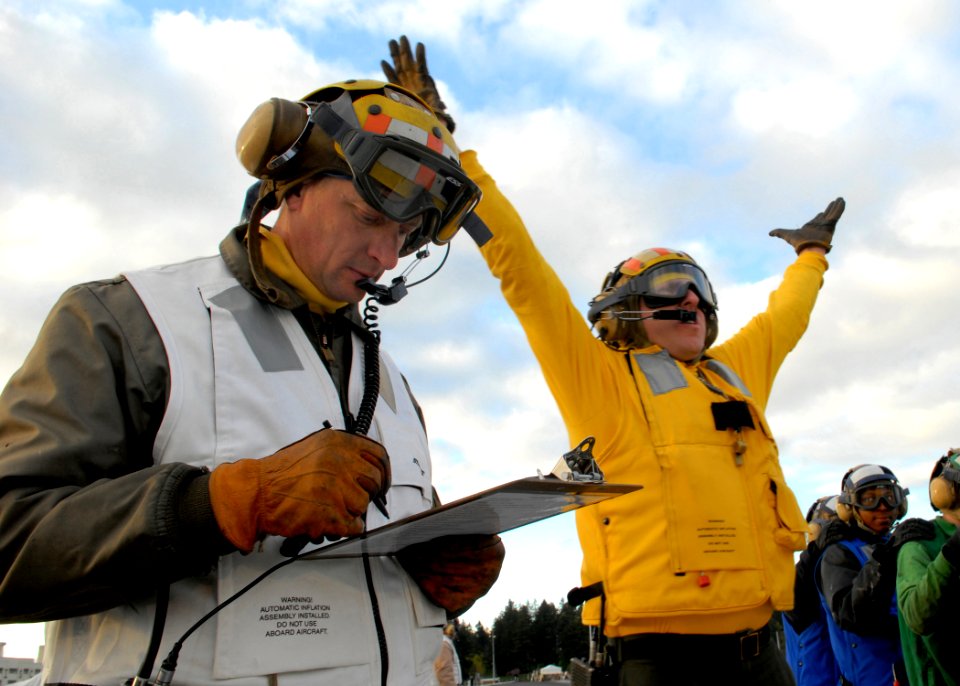 US Navy 070410-N-7981E-073 Senior Chief Aviation Boatswain's Mate John Marcella, a member of the Air Department Training Team, evaluates flight deck personnel as they respond to a simulated crash