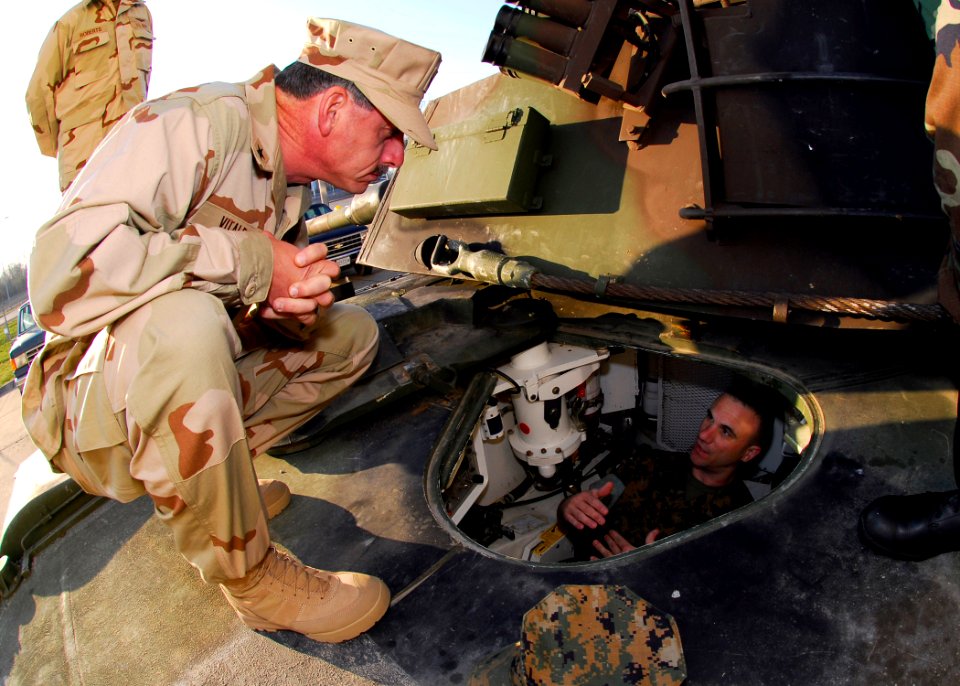 US Navy 070416-N-2903M-002 Commander, Carrier Strike Group Two Rear Adm. Mike C. Vitale is briefed on driving a M1A1 Abrams