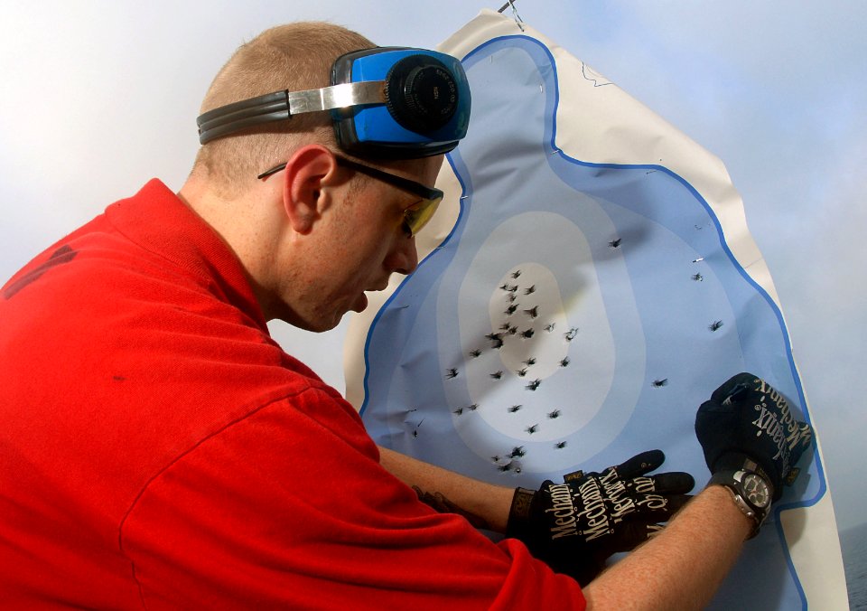 US Navy 070411-N-3038W-013 Gunner's Mate 2nd Class Robert Baker score targets during a small-arms exercise on the flight deck of the Nimitz-class aircraft carrier USS John C. Stennis (CVN 74)