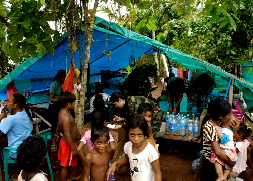 US Navy 070416-N-4790M-118 Lt. Cmdr. Eilene Herrera and Lt. Cmdr. Karlwin Matthews provide medical assistance to local families impacted by the recent earthquake and tsunami in the region