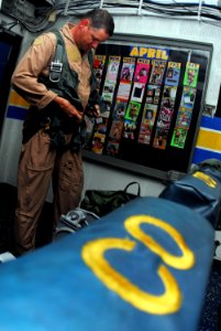 US Navy 070409-N-9928E-068 Cmdr. Michael Davis, commanding officer of the Golden Hawks of Carrier Airborne Early Warning Squadron (VAW) 112, prepares his flight suit in ready room six prior to flight operations
