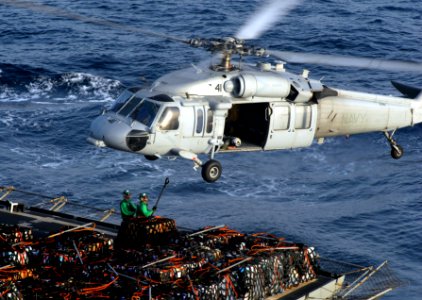 US Navy 070414-N-3038W-075 Personnel from USNS Bridge (T-AOE 10) attach pallets of supplies to an MH-60S Seahawk, from Predators of Helicopter Sea Combat Squadron (HSC) 23