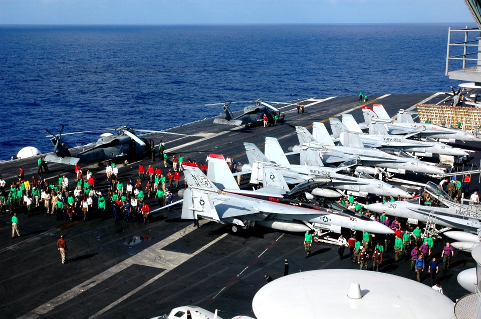 US Navy 070417-N-9760Z-044 Sailors conduct a foreign object damage (FOD) walk down on the flight deck aboard nuclear-powered aircraft carrier USS Nimitz (CVN 68)