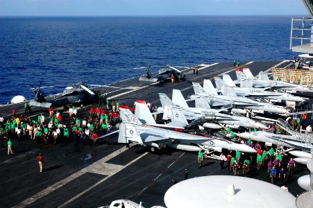 US Navy 070417-N-9760Z-044 Sailors conduct a foreign object damage (FOD) walk down on the flight deck aboard nuclear-powered aircraft carrier USS Nimitz (CVN 68)