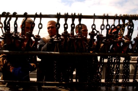 US Navy 070419-N-4009P-342 Sailors aboard USS Ronald Reagan (CVN 76) gather chains used to tether down aircraft on the flight deck