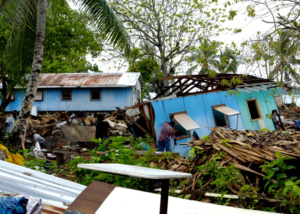 US Navy 070413-N-4790M-014 Residents try to salvage materials from houses destroyed by an earthquake and resulting tsunami