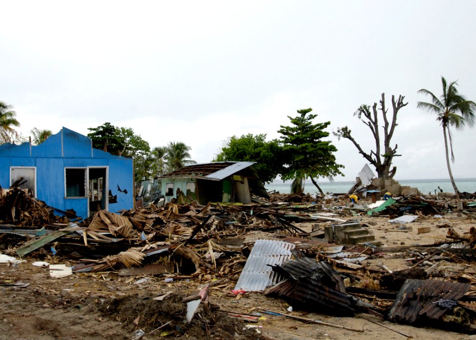US Navy 070413-N-4790M-015 Residents try to salvage materials from houses destroyed by an earthquake and resulting tsunami