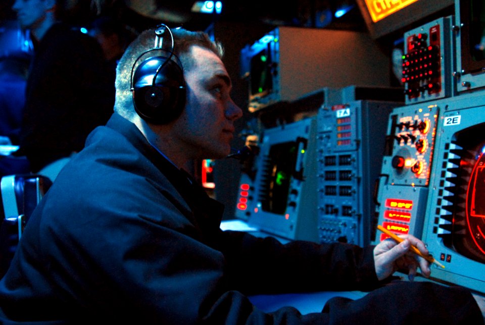 US Navy 070418-N-4124C-001 An operations watchstander, of Amphibious Squadron 11, analyzes ship movements of a synthetic battle group during a Fleet Synthetic Training exercise