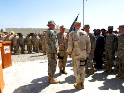 US Navy 070411-N-0000X-002 Cmdr. Dave Adams receives the guidon from the commanding officer of the 82nd Airborne Division 4th Brigade Combat Team during a change of command ceremony for Provincial Reconstruction Team Khost