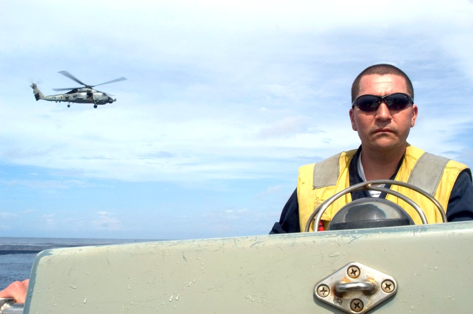 US Navy 070419-N-5253W-007 Boatswain's Mate 2nd Class Jose Martinez assigned to the Arleigh Burke-class guided-missile destroyer USS Lassen (DDG 82) maneuvers a rigid-hull inflatable boat (RHIB)