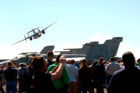 US Navy 070414-N-1635S-007 An E-2C Hawkeye, assigned to the Black Eagles of Airborne Early Warning Squadron (VAW) 113, flies over the crowd of family and friends of Sailor