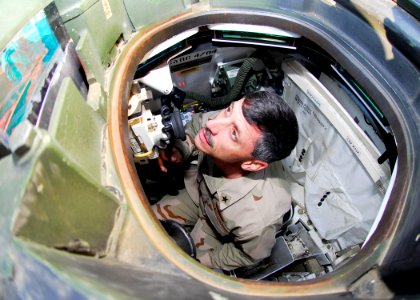 US Navy 070416-N-2903M-005 Commander, Carrier Strike Group Two Rear Adm. Mike C. Vitale peers through the commander's hatch of a U.S. Marine Corps M1A1 Abrams main battle tank