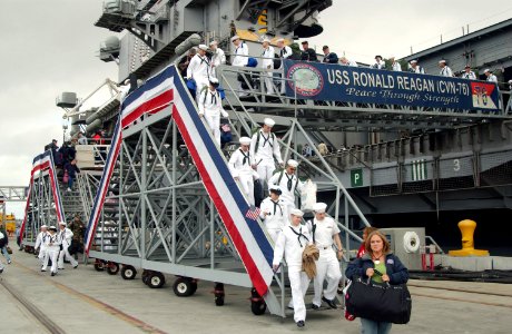 US Navy 070420-N-0555B-201 Sailors returning from a three-month surge deployment aboard USS Ronald Reagan (CVN 76) disembark the ship and rush to meet their friends and loved ones