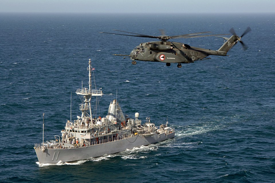 US Navy 070416-N-6501M-003 An MH-53E Sea Dragon assigned to Helicopter Mine Counter Measure Squadron (HM) 15 conducts a mine sweeping exercise with the Avenger-class mine countermeasure ship USS Gladiator (MCM 11)