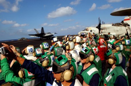 US Navy 070415-N-4009P-345 Sailors and civilians watch as an F-A-18C Hornet, assigned to the photo
