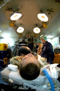 US Navy 070414-N-8154G-176 Doctors and hospital corpsmen attached to Fleet Surgical Team (FST) 6 simulate surgery on a member of dock landing ship USS Oak Hill (LSD 51) Visit, Board, Search and Seizure (VBSS) Team