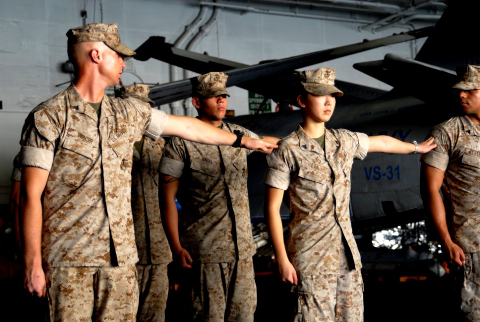 US Navy 070421-N-3038W-097 Marines from the Death Rattlers of Marine Strike Fighter Squadron (VMFA) 323 line up in ranks during the Corporal's Course in the hangar bay aboard Nimitz-class aircraft carrier USS John C. Stennis (C