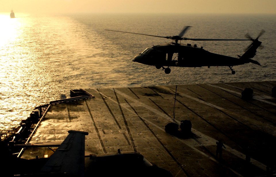 US Navy 070414-N-3038W-053 An MH-60S Seahawk, from the Predators of Helicopter Sea Combat Squadron (HSC) 23, sets down supplies aboard Nimitz-class aircraft carrier USS John C. Stennis (CVN 74) during a vertical replenishment