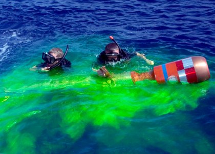 US Navy 070419-N-5253W-008 Hull Technician 3rd Class Tyler Nilsson (left) and Boatswain's Mate 3rd Class Matthew Loeffler, rescue swimmers aboard the Arleigh Burke-class guided-missile destroyer USS Lassen (DDG 82), recover a p