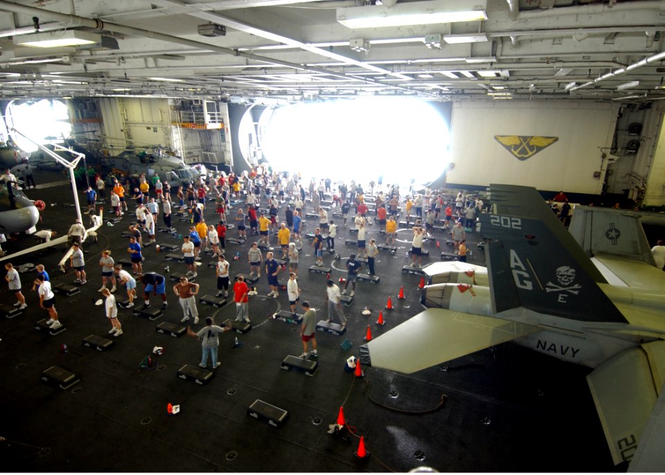 US Navy 070414-N-6854D-005 Sailors prepare to participate in a two-hour aerobics class held in the hangar bay of Nimitz-class aircraft carrier USS Dwight D. Eisenhower (CVN 69)