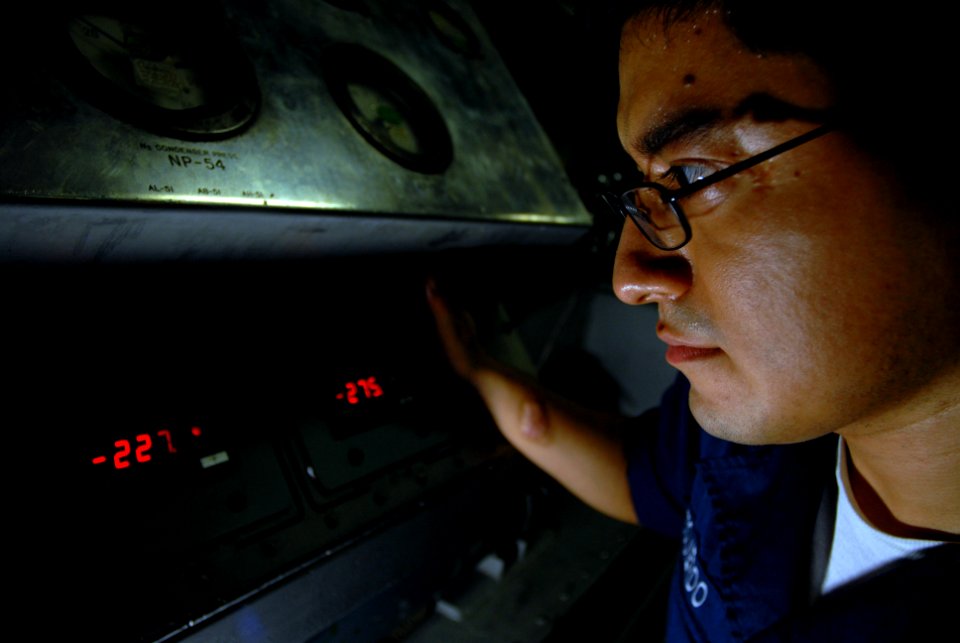US Navy 070420-N-2659P-026 Machinist's Mate 2nd Class Jorge Izquierdo checks the temperature of liquid oxygen (LOX) in a GB-25 LOX producing machine