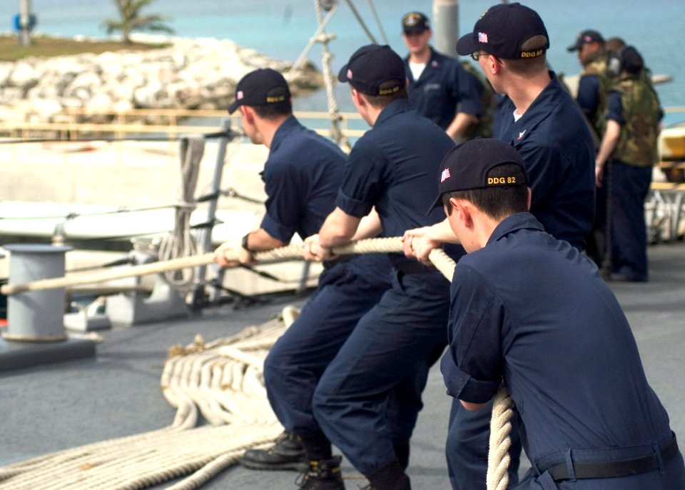 US Navy 070414-N-5253W-002 Line handlers aboard the Arleigh Burke-class guided-missile destroyer USS Lassen (DDG 82) heave on the forward mooring line as the ship pulls into Guam