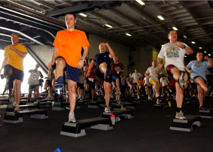 US Navy 070414-N-6854D-007 Sailors participate in a two-hour aerobics class held in the hangar bay of Nimitz-class aircraft carrier USS Dwight D. Eisenhower (CVN 69)