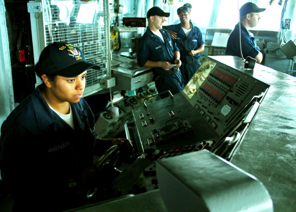 US Navy 070418-N-1328S-003 Seaman Cindy Osegueda steers amphibious assault ship USS Boxer (LHD 4) while underway in the Arabian Sea