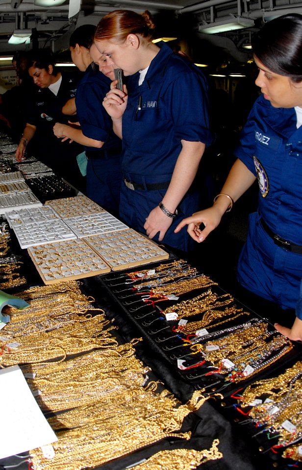 US Navy 070420-N-3038W-077 Sailors look at silver and gold jewelry from vendors on the aft mess decks aboard the Nimitz-class aircraft carrier USS John C. Stennis (CVN 74)