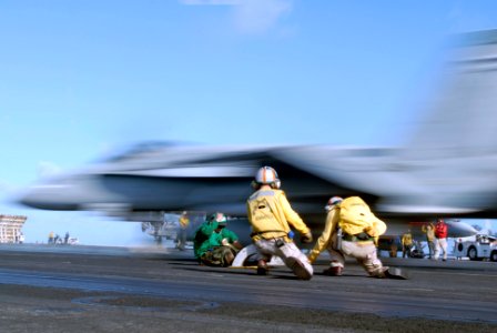 US Navy 070420-N-5484G-098 Lt. Cmdr. Jason Wood and Lt. Matthew Ligon signal to launch an F-A-18C Hornet from catapult three of nuclear-powered aircraft carrier USS Nimitz (CVN 68)