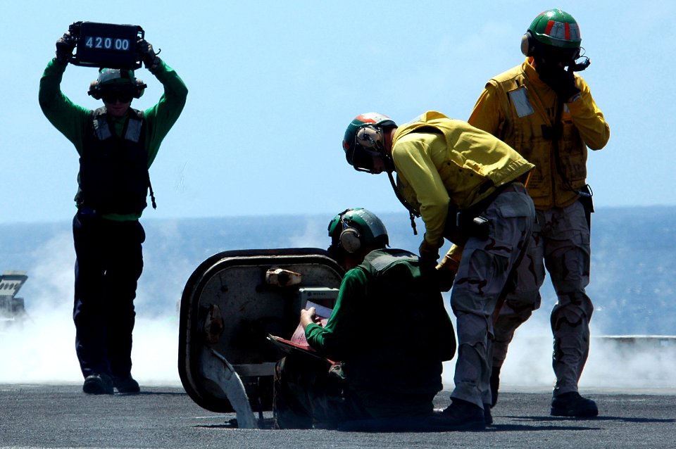 US Navy 070425-N-9760Z-039 Sailors confirm the weight of an aircraft to assure that the catapult pressure is correct aboard nuclear-powered aircraft carrier USS Nimitz (CVN 68)