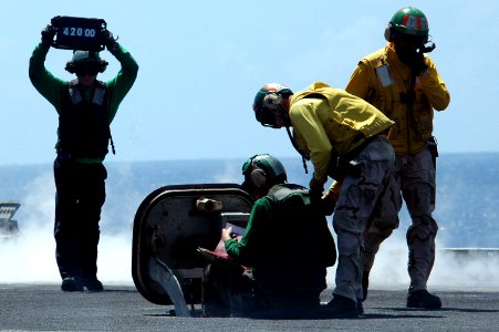 US Navy 070425-N-9760Z-039 Sailors confirm the weight of an aircraft to assure that the catapult pressure is correct aboard nuclear-powered aircraft carrier USS Nimitz (CVN 68)