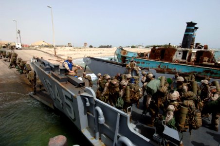 US Navy 070420-N-9818V-153 Marines attached to the 26th Marine Expeditionary Unit out of Camp Lejeune, N.C., disembark a landing craft utility assigned to Assault Craft Unit (ACU) 2 for an offload of troops and equipment from t