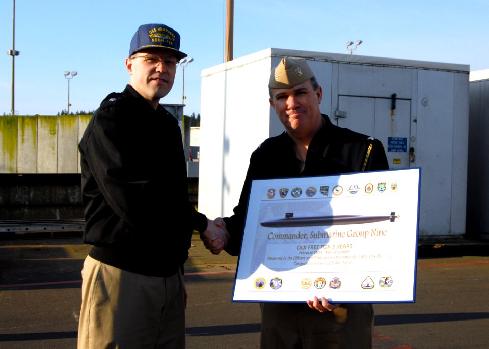 US Navy 070420-N-7656R-001 USS Nebraska (SSBN 739) (Blue) Commanding Officer receives an award from Chief of Staff Commander Submarine Group 9, Capt. Kenneth Walker for his crew staying DUI free for the past two years