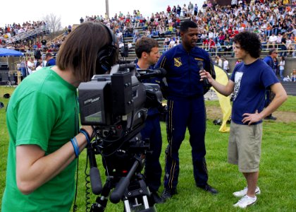 US Navy 070418-N-2903M-085 Senior Chief Special Warfare Operator Lance Leafers and Special Warfare Boat Operator 1st Class Dave Fisher of the Navy Parachute Team are interviewed by a student TV news crew after a performance at