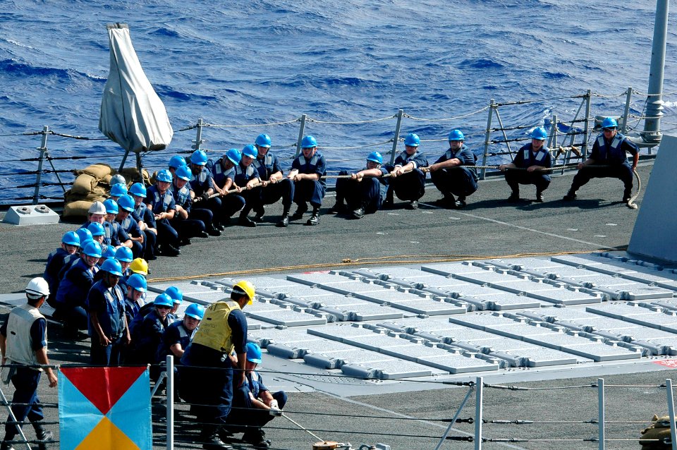 US Navy 070417-N-9760Z-109 Sailors aboard guided missile destroyer USS Chafee (DDG 90) pull a line taut to secure the fuel line while conducting an underway replenishment (UNREP)