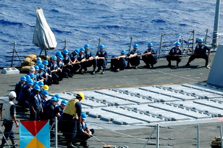 US Navy 070417-N-9760Z-109 Sailors aboard guided missile destroyer USS Chafee (DDG 90) pull a line taut to secure the fuel line while conducting an underway replenishment (UNREP)