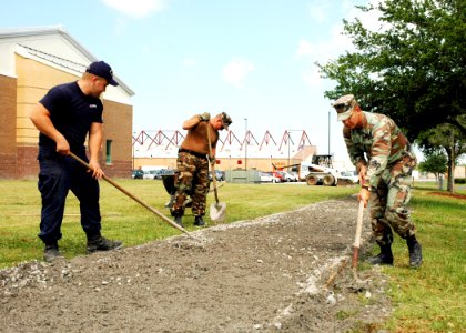 US Navy 070426-N-7427G-001 Seabees assigned to the Public Works department install a new sidewalk outside of the Naval Operational Support Center on Naval Air Station Joint Reserve Base New Orleans photo